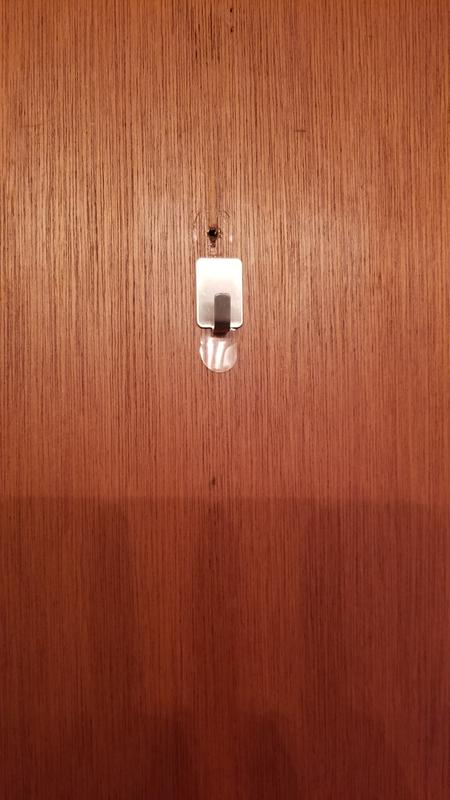 Bathroom door w/hole from previous hook.