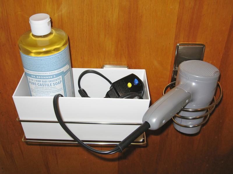 3M Organizer and Hair Dryer Holder remain securely attached to a varnished wood door.