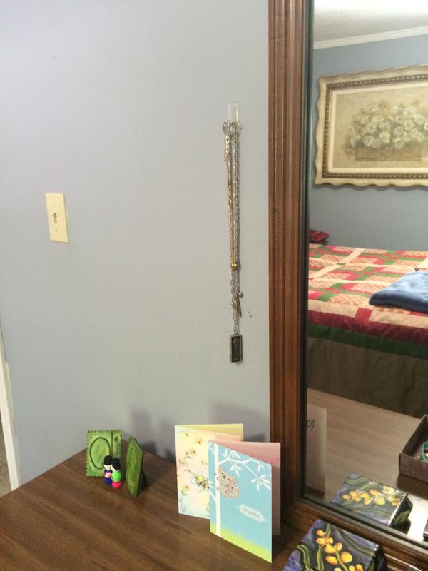 clear base and command strip blends in with the wall color