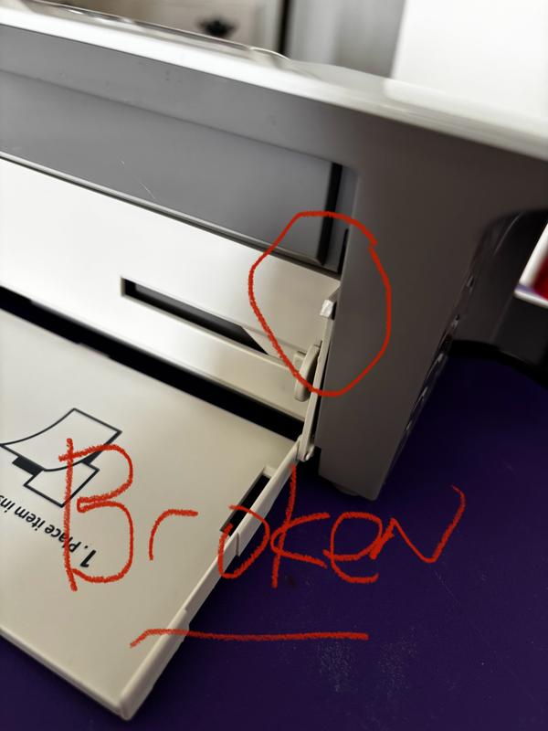 The second photo shows input tray broken unlike the first photo