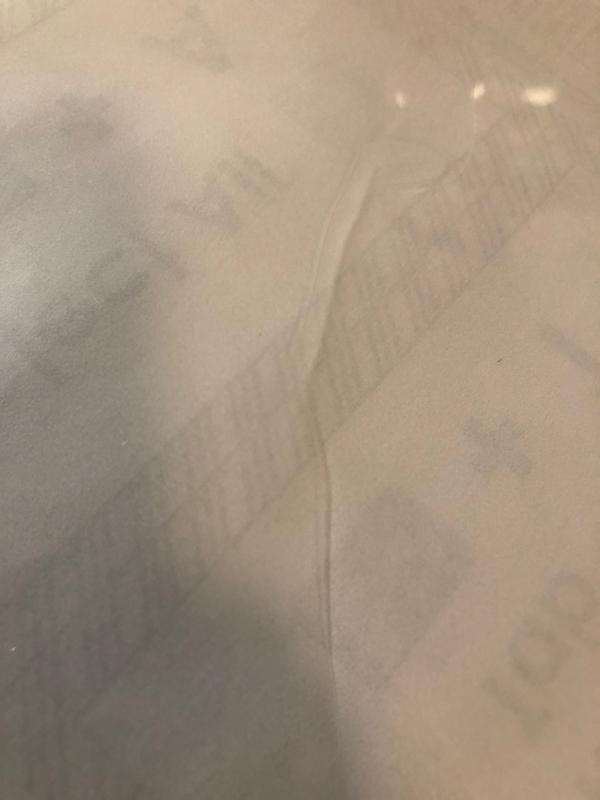 Crease in the laminating pouch.