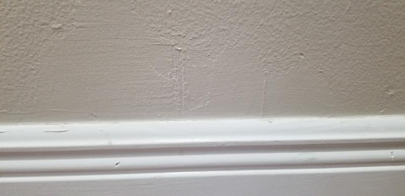 Baseboard and wall lined and painted perfecrly