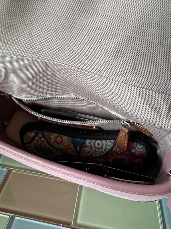 Plenty of room for phone, reading glasses, sunglasses and lipstick. Has a zip side pocket too