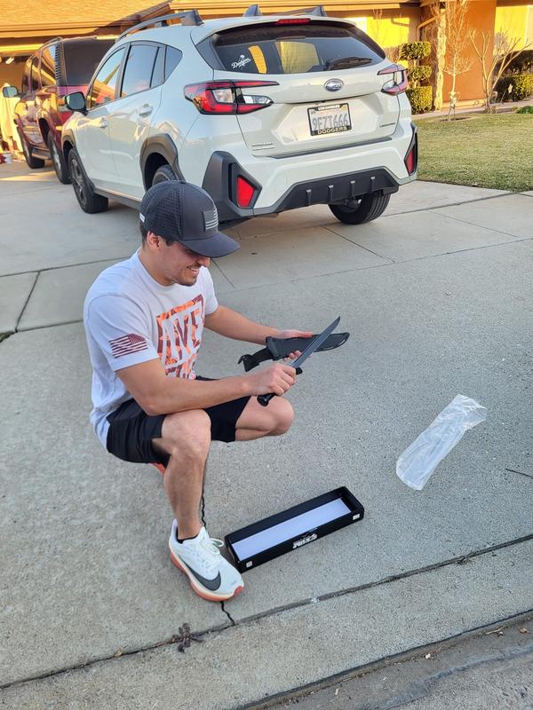 Opening his late Christmas present in the driveway