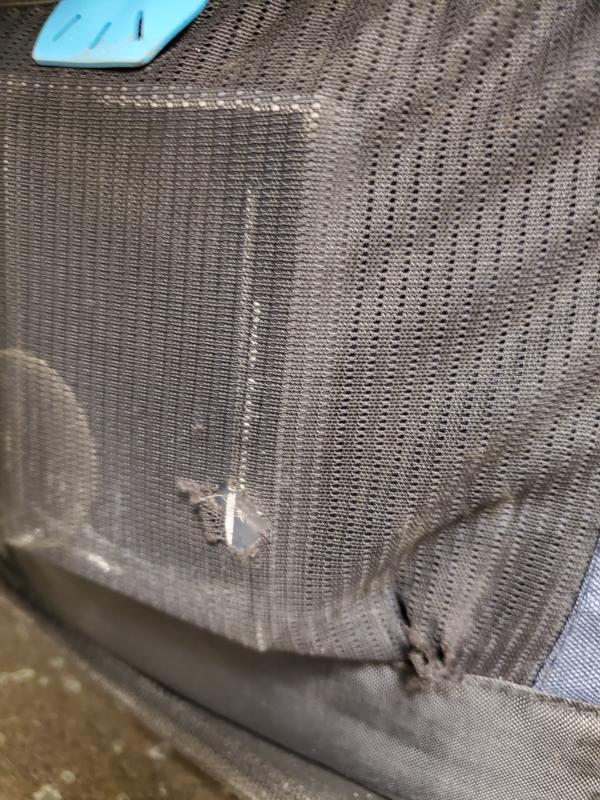 Close up on tears on side mesh outside pocket