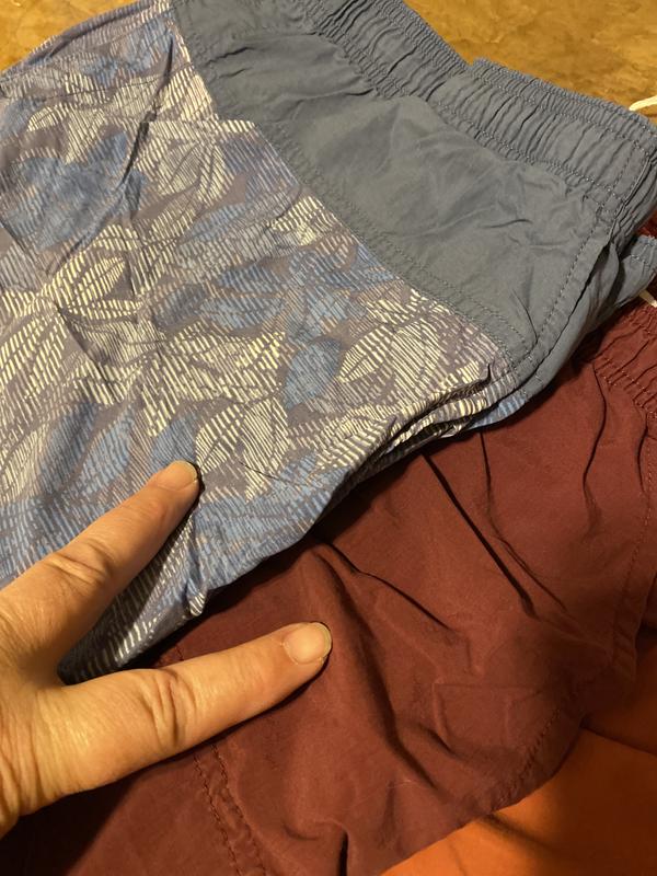 The blue is much older, made in Vietnam, pocket is not attached to the short, no bunching.