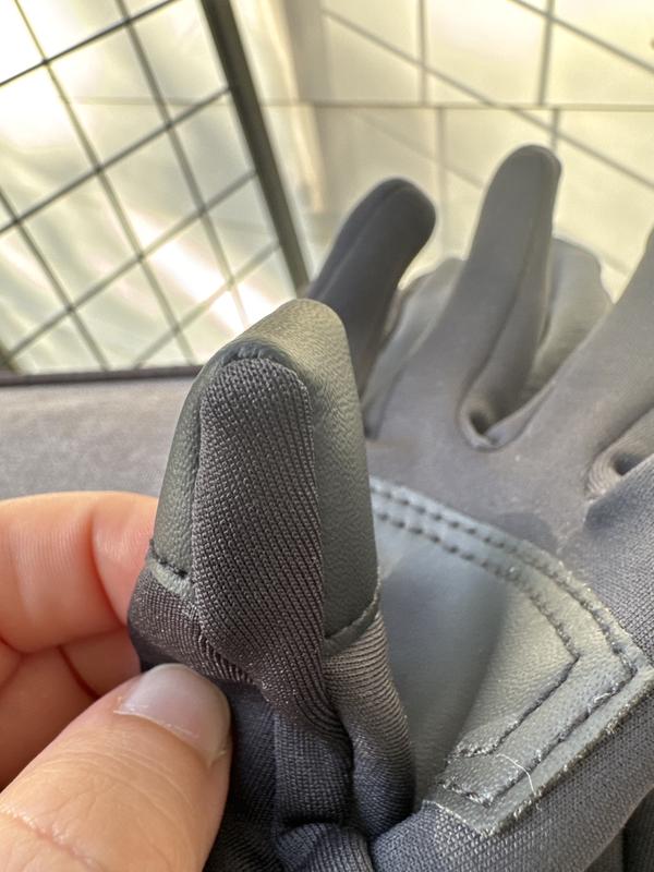 Thumb grip sewn into