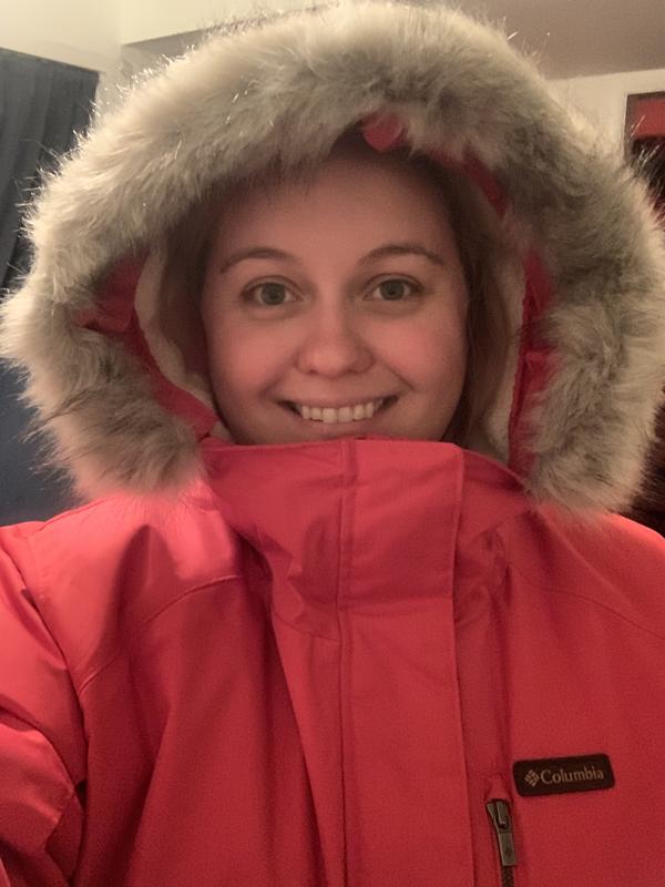 Photo showing the coat fully zipped and hood up.