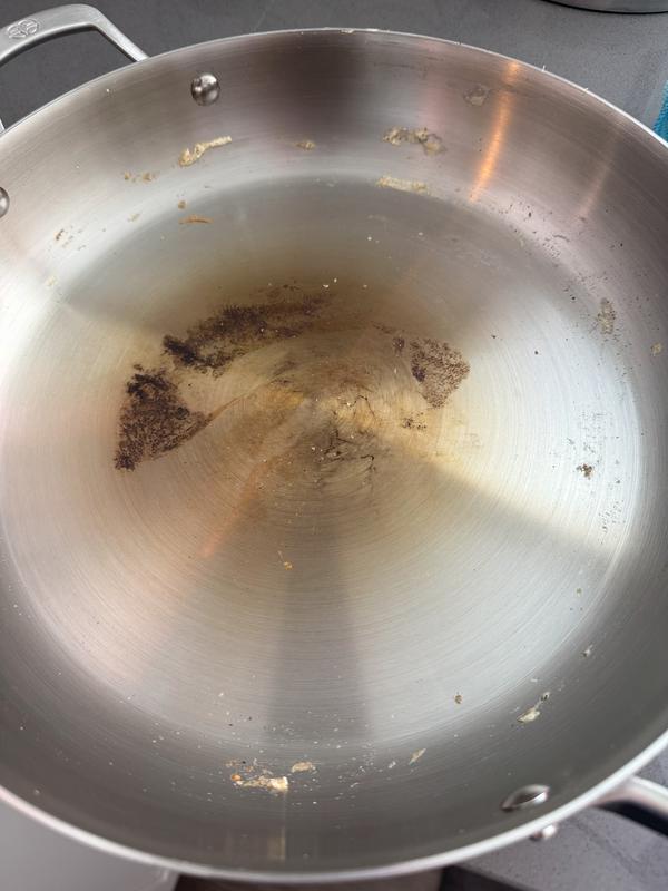 Burnt residue after scraping with wooden spatula