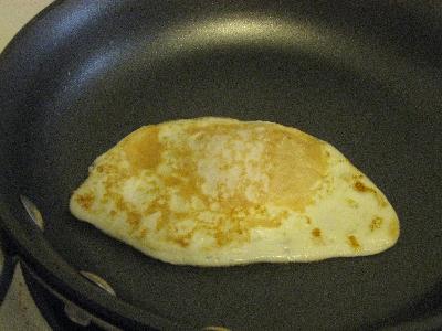 Fried egg cooked with the yolk runny using no oils or butter!