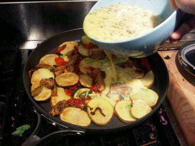 1. Adding the eggs to fried potatoes
