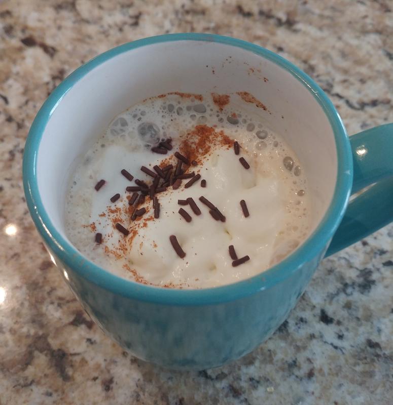 Vanilla oat milk latte with cinnamon and chocolate sprinkles