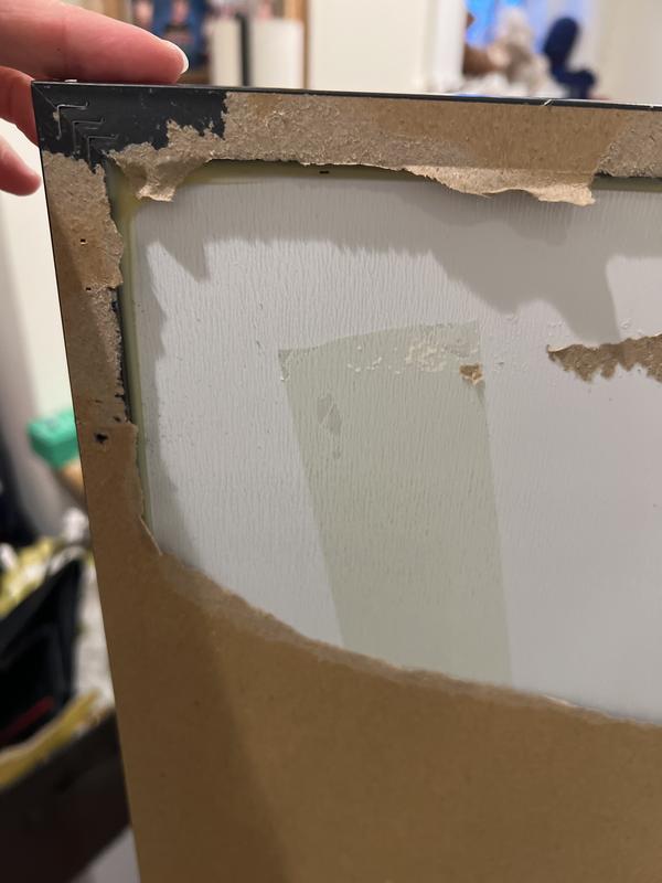 Tried to screw into the frame. Frame too soft. Pulled off the paper to see if there were pre drill holes beneath, as per the location on the instructions