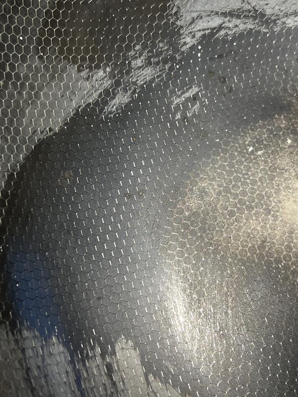 The worn spot is from rubbing with salt and oil in an attempt to naturally remove the spot.