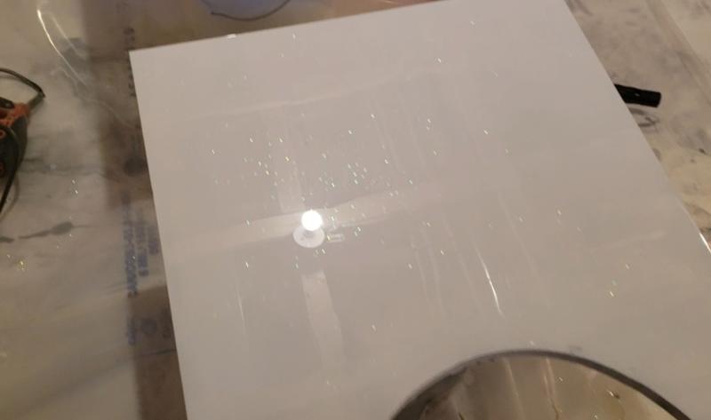 White spray paint,  glitters and epoxy.