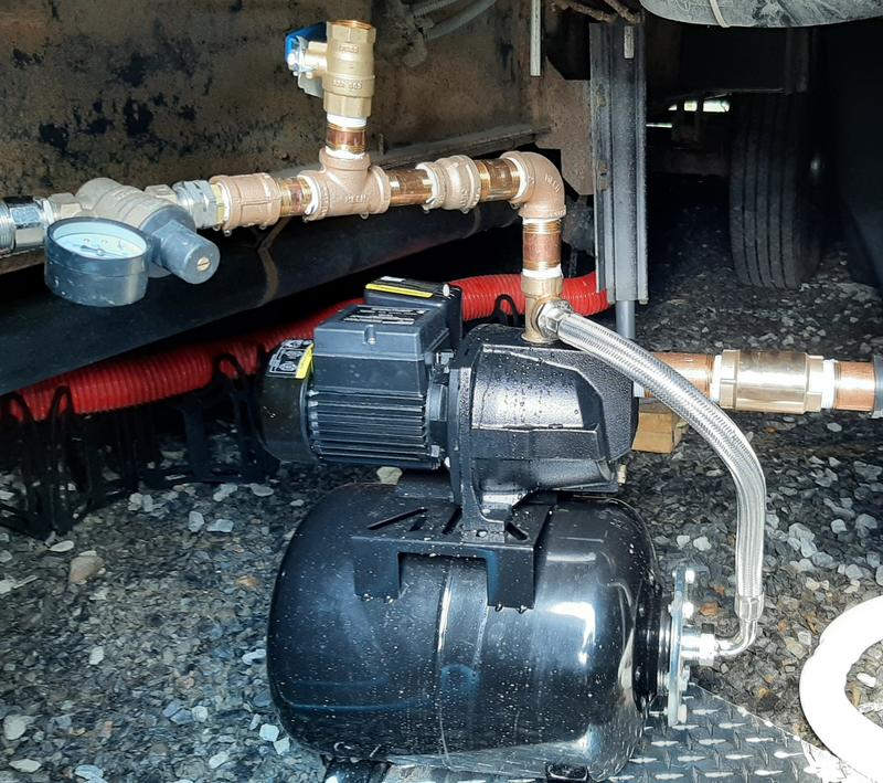 Complete setup under slide of 44' Road Warrior Toy Hauler, including Pressure Regulator (left) and Foot Valve/backflow preventer valve(right)