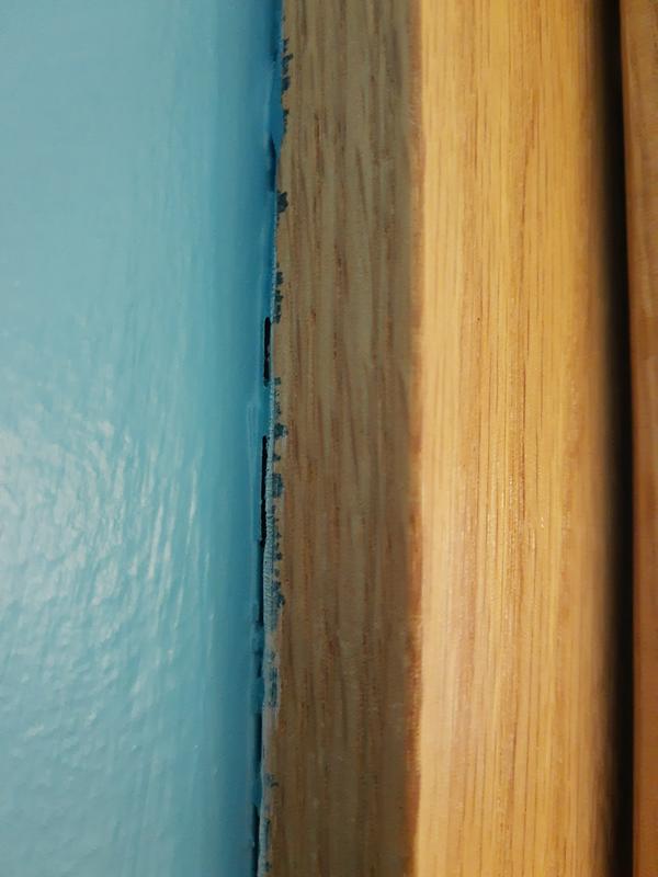 The blue paint bled under the tape and got all over the wood trim.