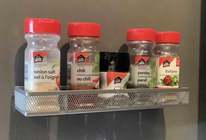 Four ceramic magnets holding the spice rack on the fridge