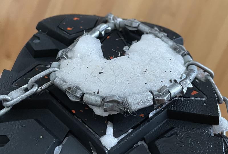 Snow clumps inside gripper ring, heel and toe