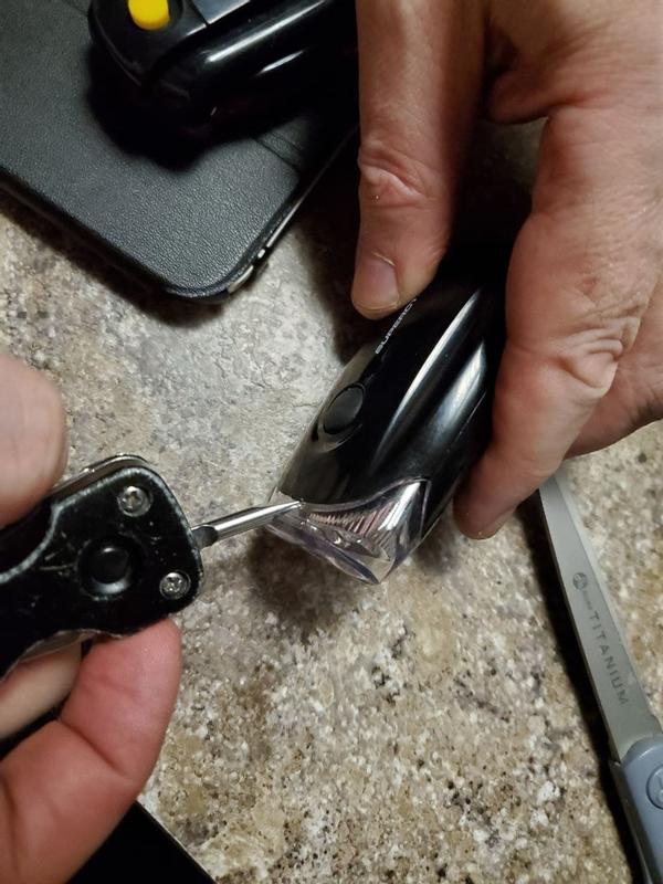 insert your flat blade here, centered on the unit, angled back wards as you go, separate a small catch located just inside here.