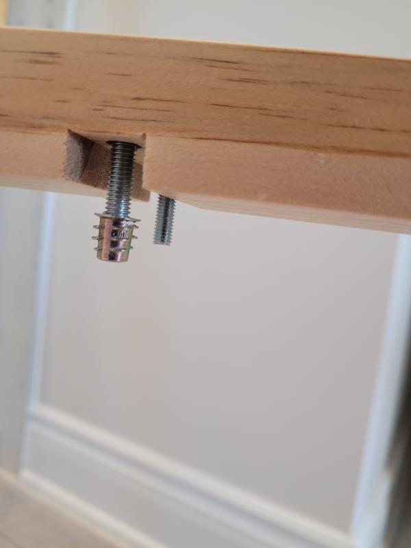 The piece that came out of the wood because the paint didn't allow the screw to function properly