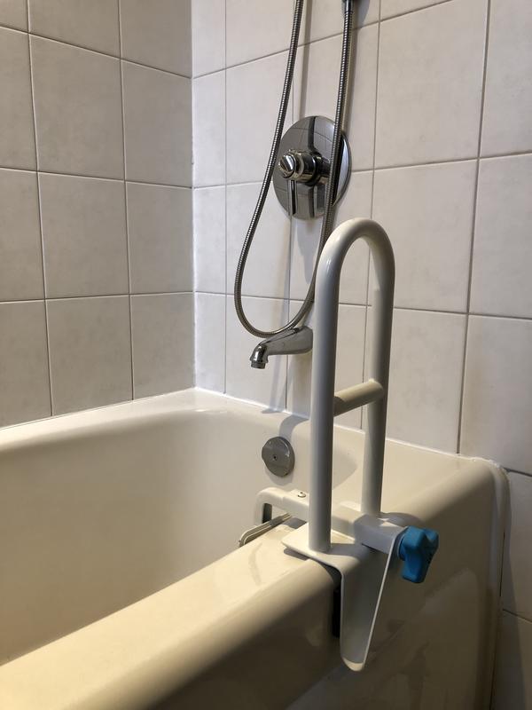 Black rubber shims used to better clamp safety rail to tub