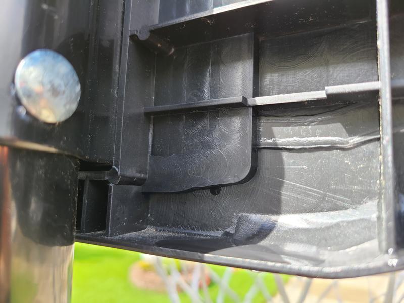crack on plastic right of silver bolt
