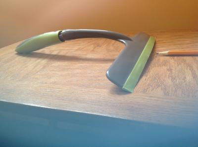 Frank bathroom squeegee with curved blade and loosened handle grip