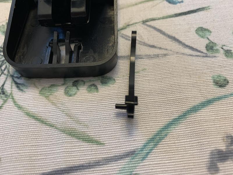 Plastic arm that sets trap missing its tab on one side