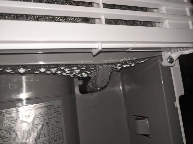 Drain bucket removed - visible condensation around drain outlet which fills up the drain bucket and halts continue drainage.