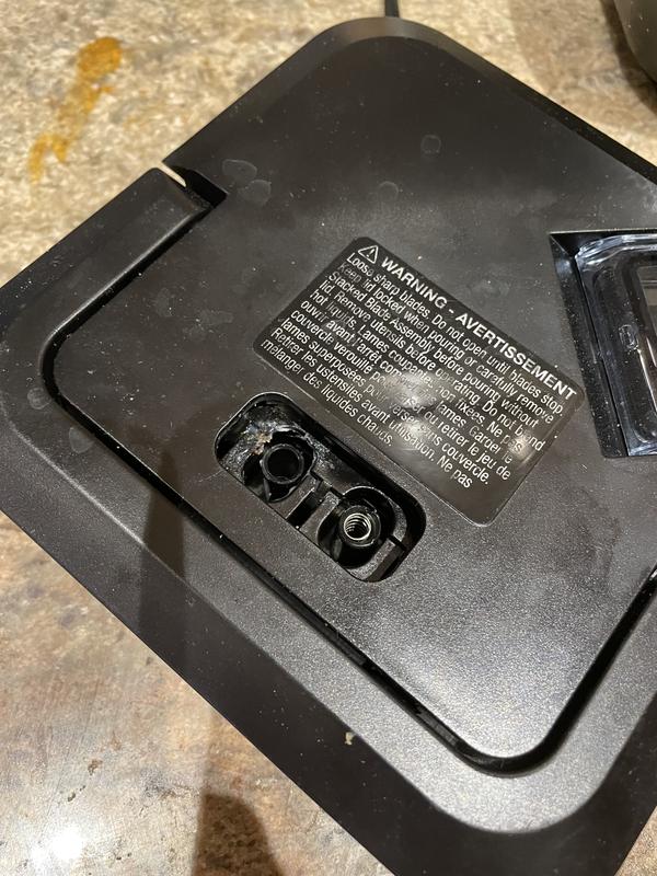 The holes where the unlocking tab is supposed to go.