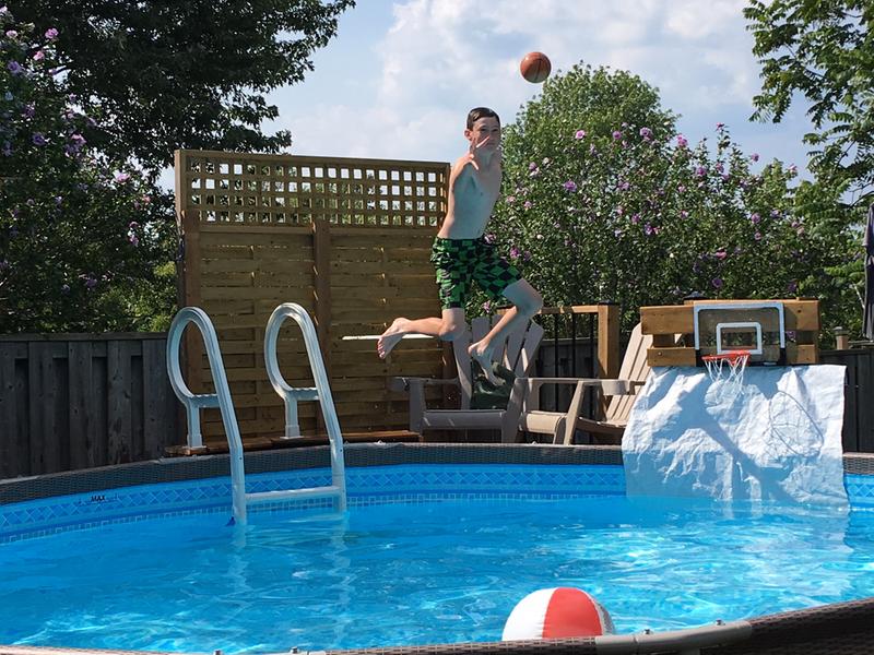 12 yr old jumping into the pool to shoot basketball