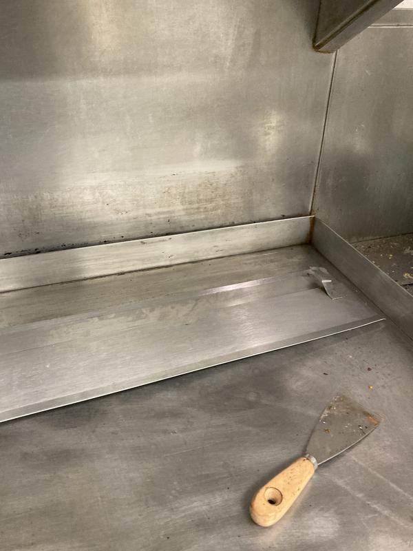 Before and after cleaning back of grill table.