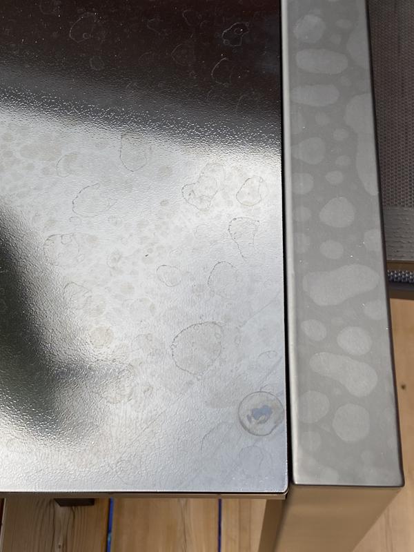 Tabletop with permanent rain watermarks (one night of rainfall)