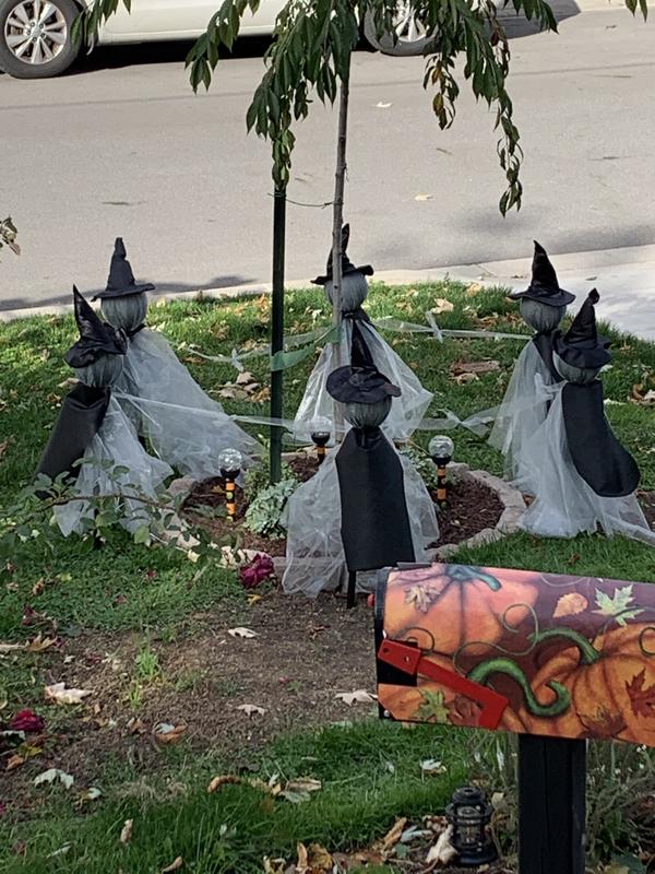 I cut capes for them out of some leftover lawn fabric and secured them with safety pins.  They look more like witches now.