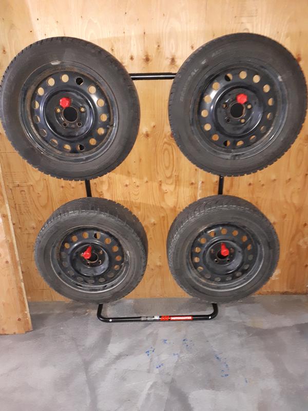 Mounted to plywood screwed to drywalled wall. Tires are 24 inches in diameter.