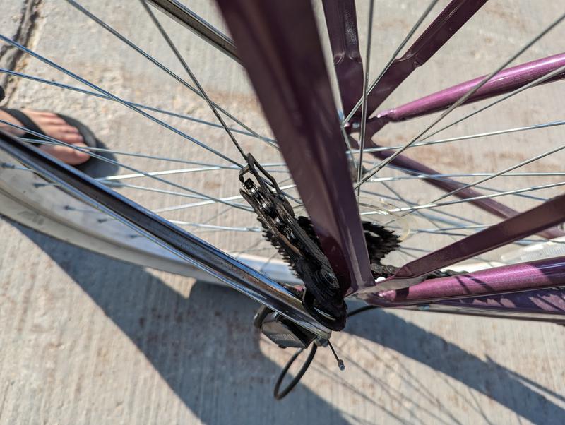 Derailleur twisted up and around and jammed in the spokes.