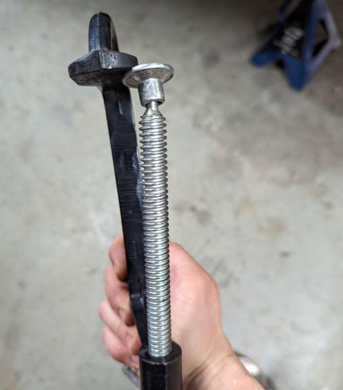 Bent sideways and deformed. Threaded rod no longer lines up with clamp body
