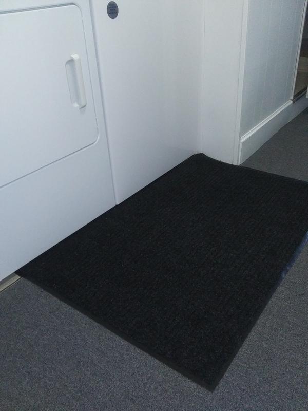 Mat anchored by washer and dyer