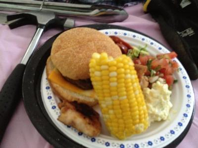 dinner of burger, chicken, corn and potato salad/salsa
