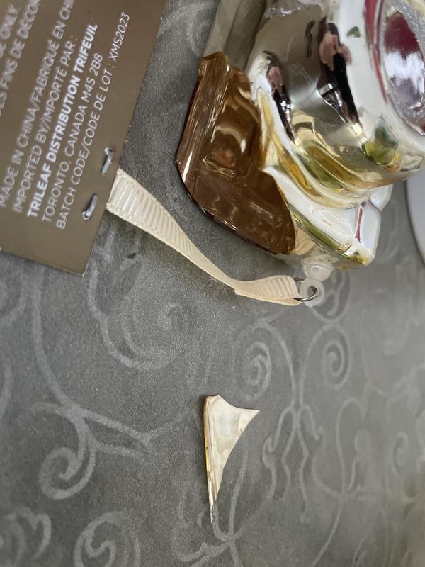 Broken by handling to remove the tag and ribbon.