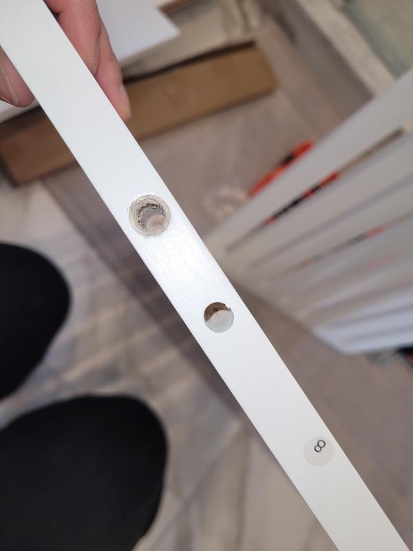 The large hole is where the piece came out of. The small hole is where there should have been a metal insert that allows the screws to attach.