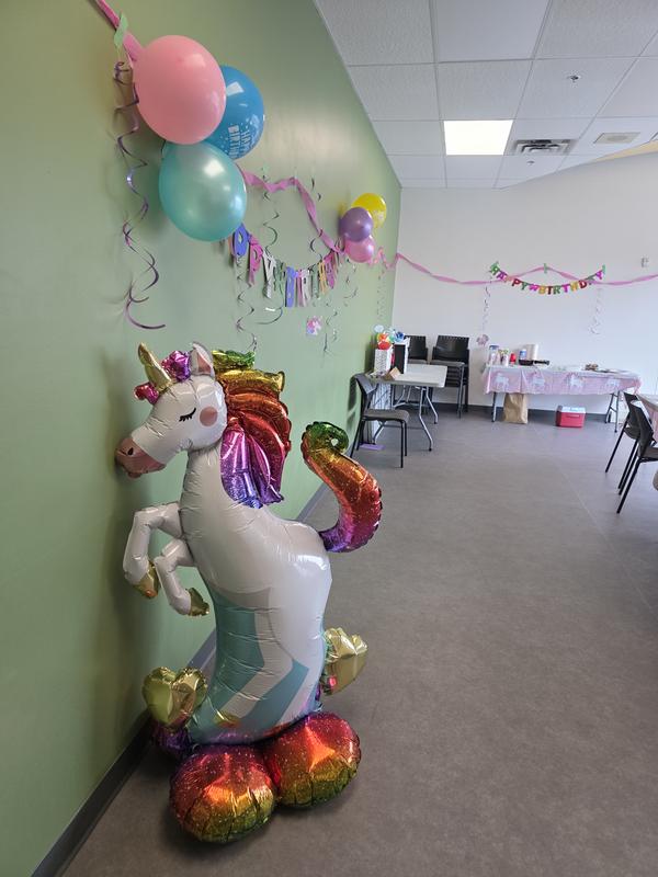 The unicorn balloon inflated at a birthday party