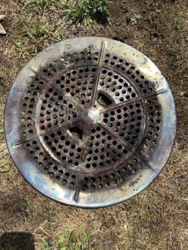 The grate the ash sits on top of that has to be removed to dump the ash pan below. The blue & purple colour is the same inside the stove itself. After just 1 fire.