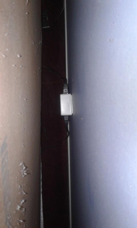 Plugged into the outlet behind the headboard.