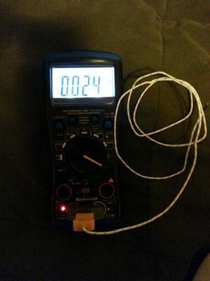 Multimeter with back light turned on, and temperature probe (Sold Separately)