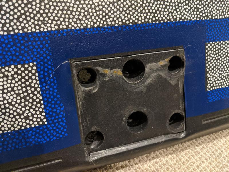 cracked backboard where the rim hangs