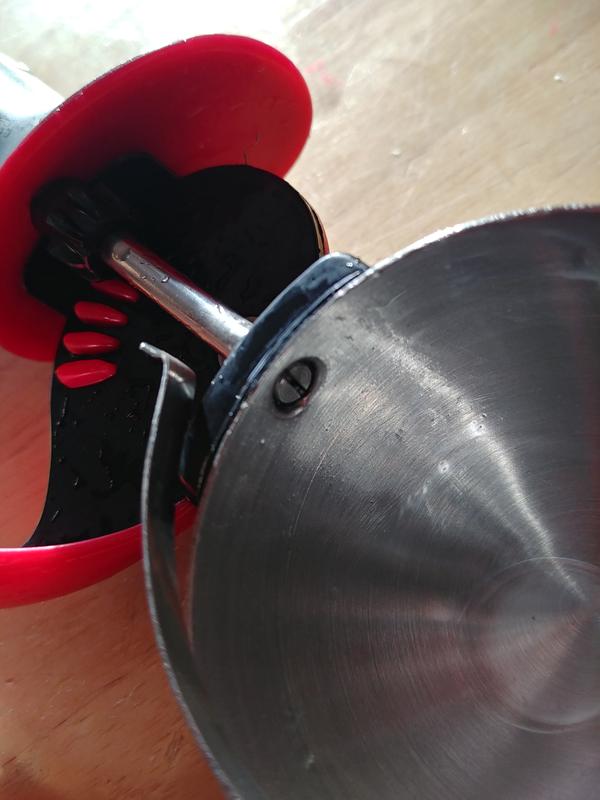 The notch on the scraper rod where the bottom end of the scraper attaches to