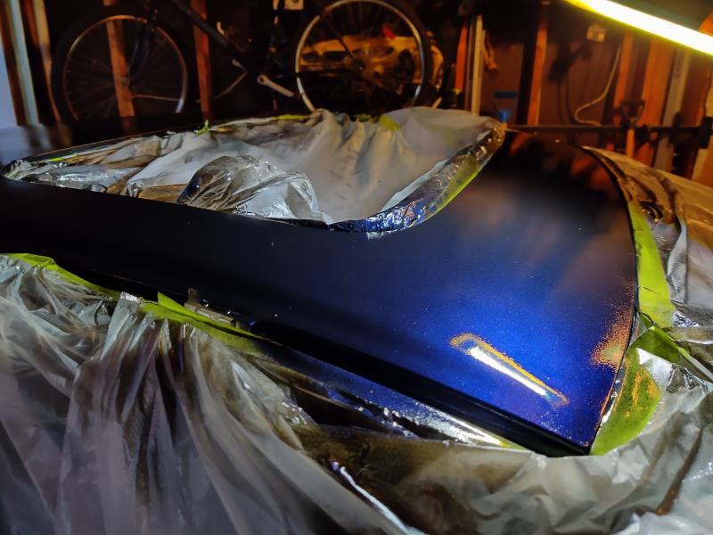 Under bright light, there are a lot of metallic blue sparkles. The original paint only has 20% sparkles, this has about 70% sparkles that you can barely see the black under the metallic in some light.