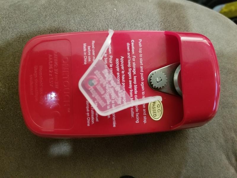 Bottom section, including the "blow a kiss at it and it falls off" blade cover.  Note a good portion of the blade sits outside of any sort of shielding or safety measure when that cover is off, which it must be in order to use the opener..